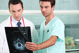 Doctor and a nurse looking at X-Ray of a traumatic brain injury