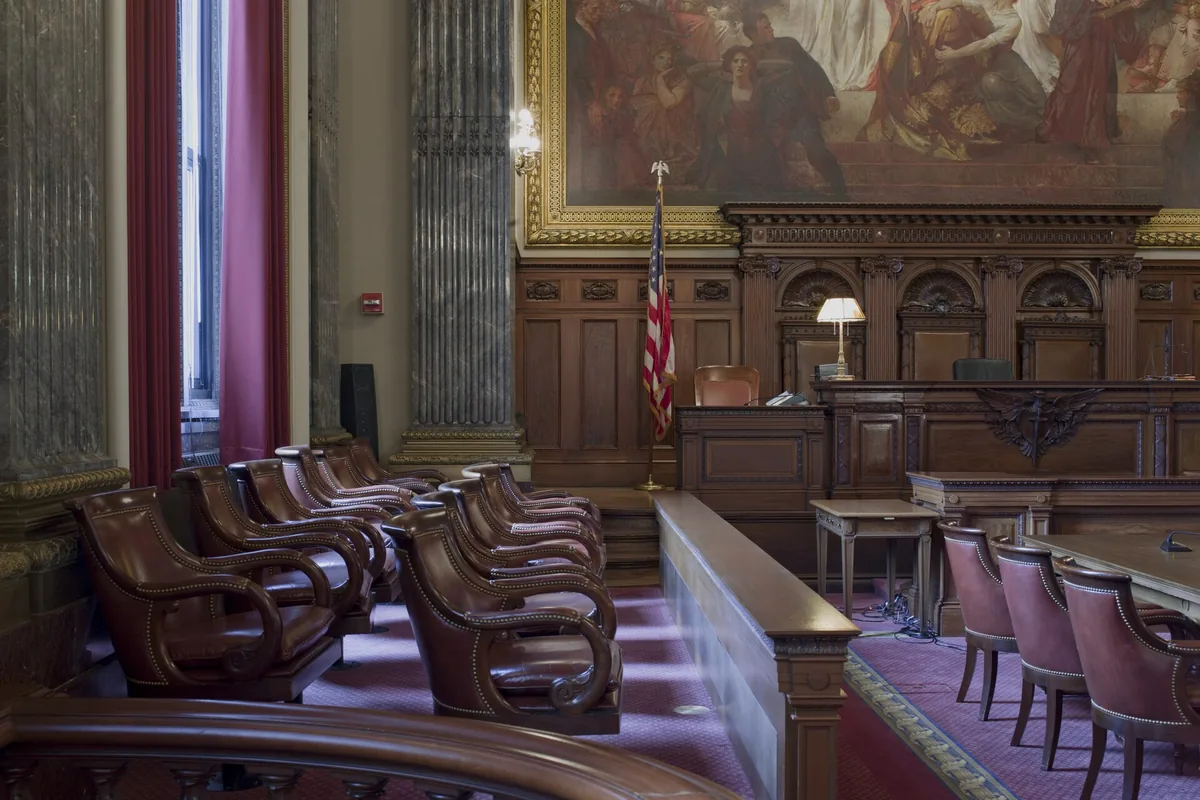 Empty jury box chairs facing the bench in a United States courtroom.