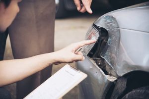 Insurance agent working during on site car accident claim process